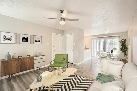 A living room with a white couch, a green chair, and a rug with black and white stripes.
