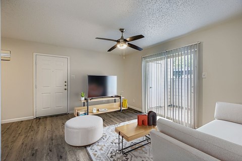 A bedroom with a large bed and a ceiling fan.