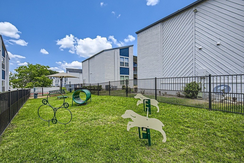 A playground with a green slide and a white rabbit slide.