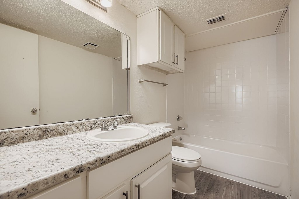 A white building with a sign that says RISE LEASING OFFICE.