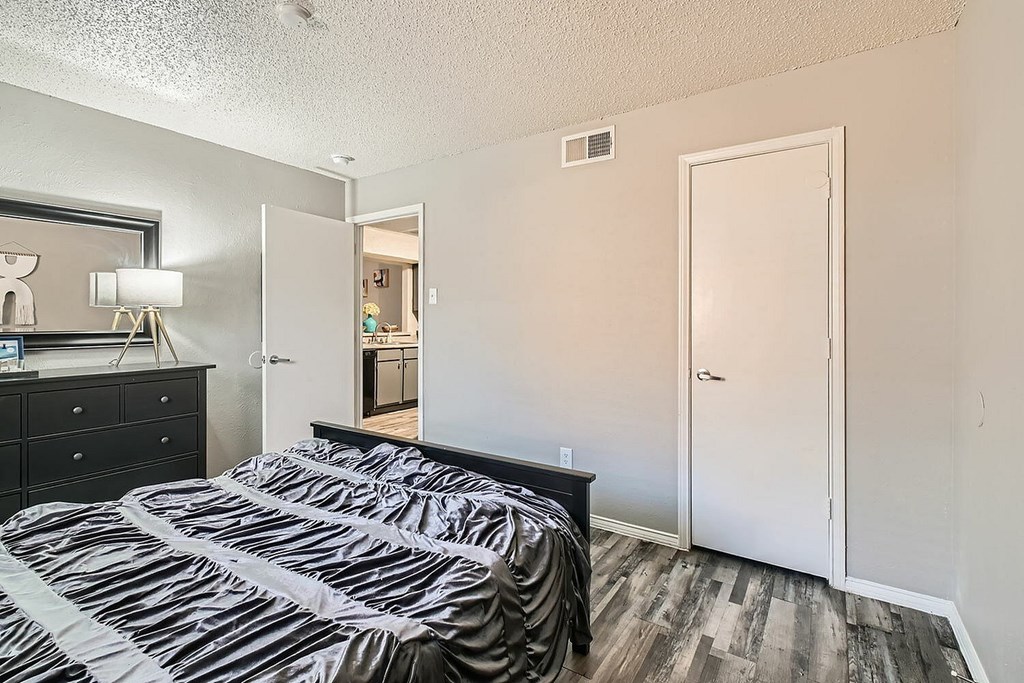 A bedroom with two beds and a dresser.