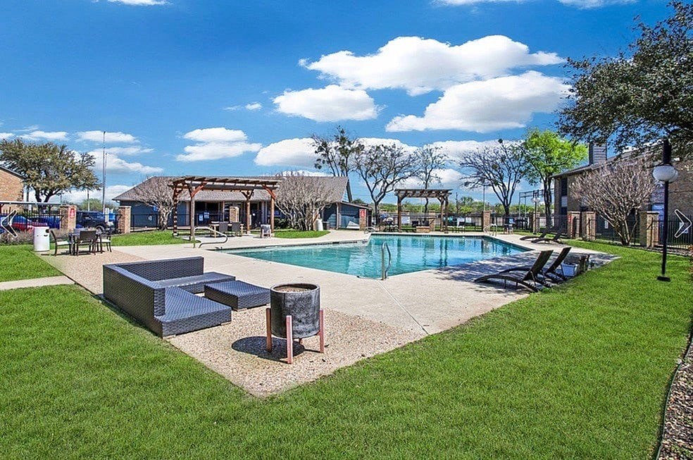 A pool area with a small pool and a hot tub.