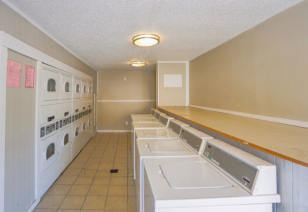 A laundromat with rows of washers and dryers.