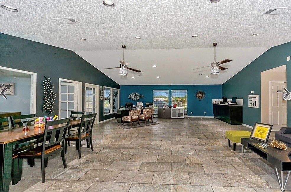 A living room with a dining table and chairs.