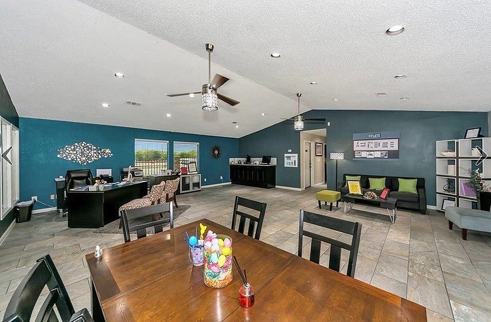 A dining room with a wooden table and chairs.