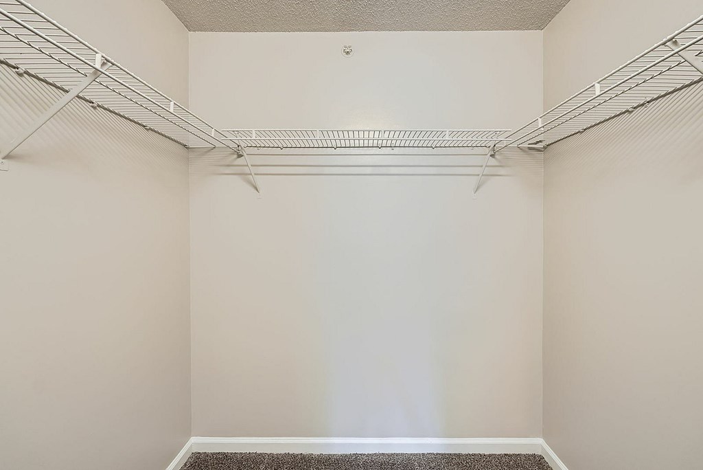 Empty room with white walls and a carpeted floor.