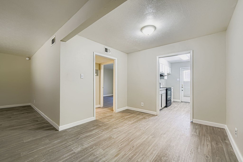 A room with a wooden floor and white walls.