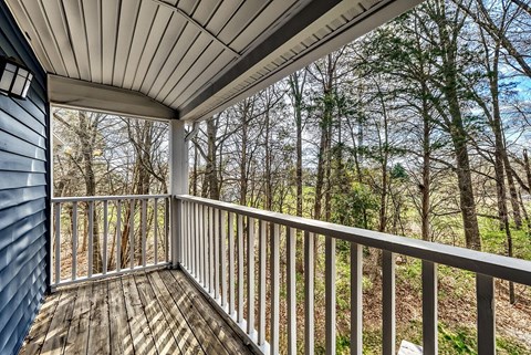 A spacious room with a ceiling fan and carpeted floor.