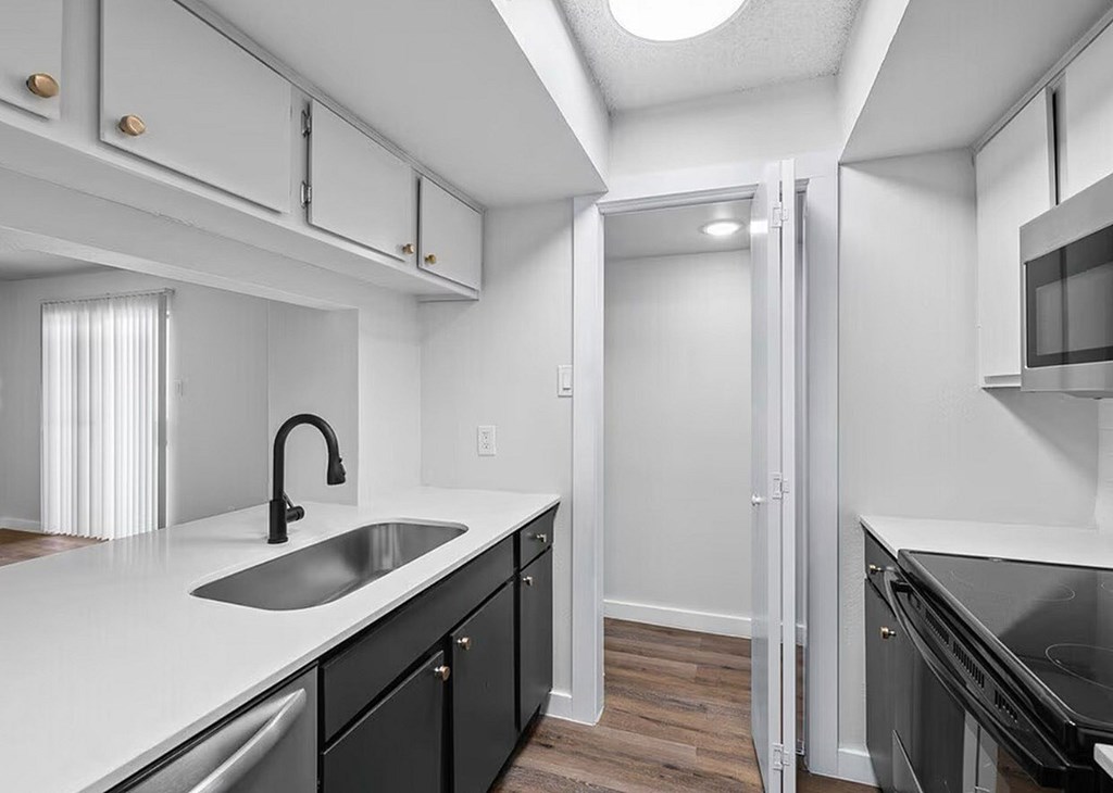 A modern kitchen with a sink and cabinets.