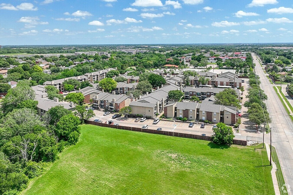 A suburban neighborhood with houses and green lawns.