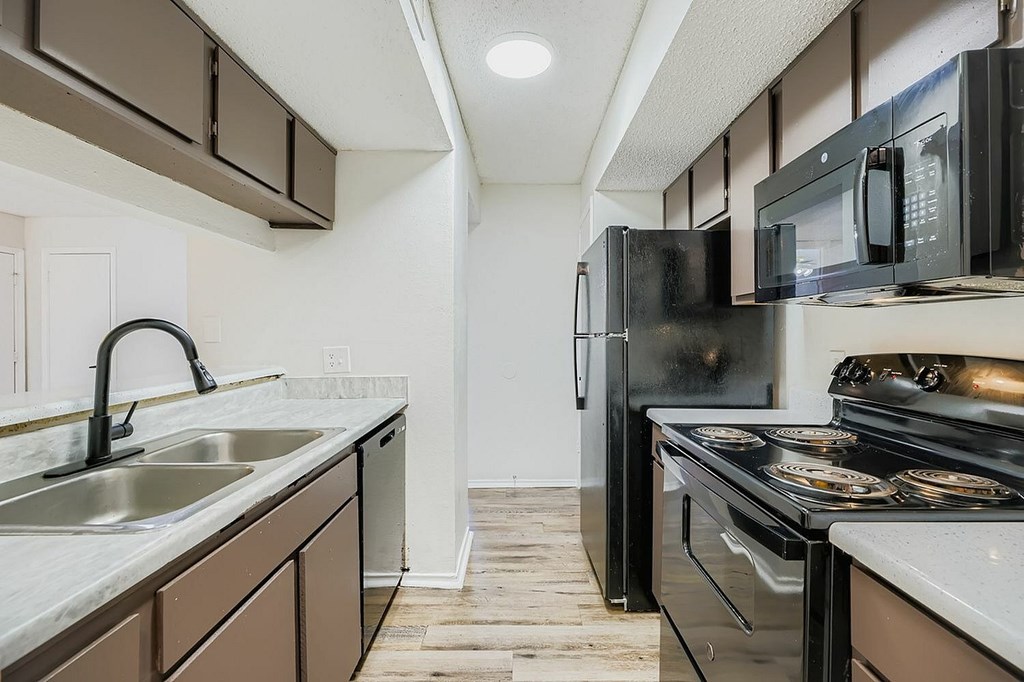 A residential building with a well-maintained front yard and a clear sky.