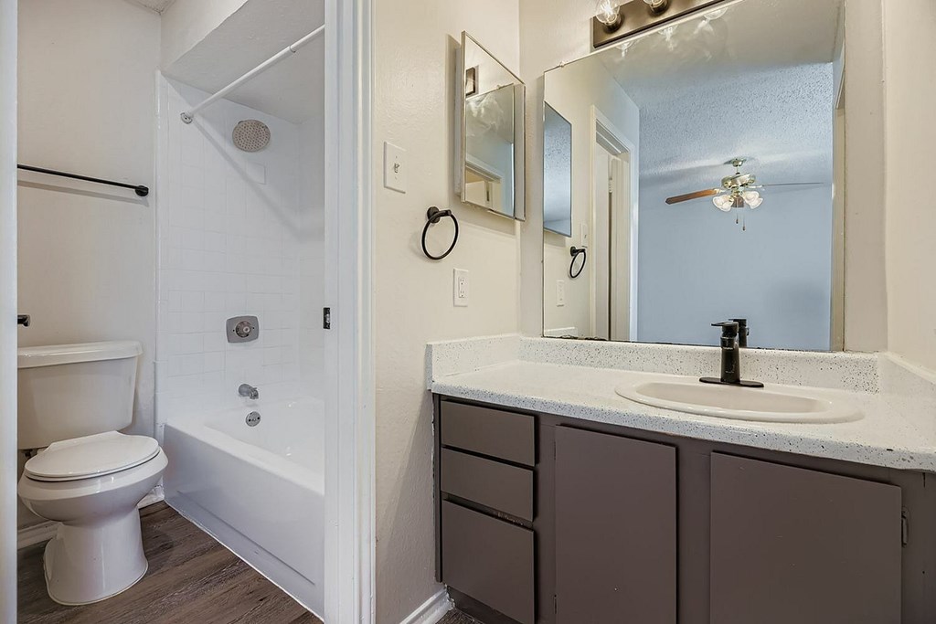 A white toilet is next to a white sink in a bathroom.