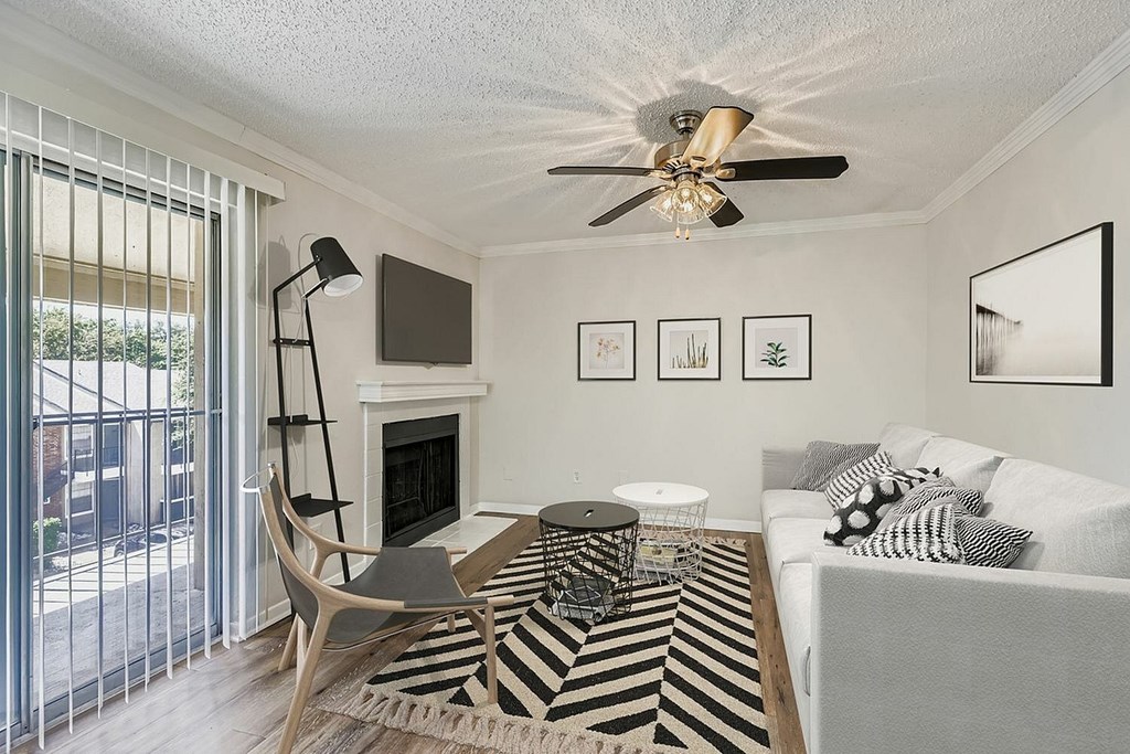 A living room with a grey couch and a wooden coffee table.