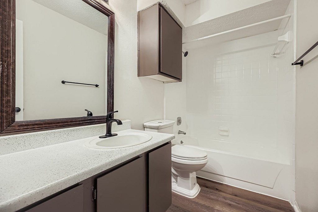 A white sink and toilet in a bathroom.