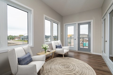A living room with a white couch and a rug.