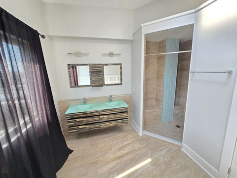 A bathroom with a sink and a mirror.