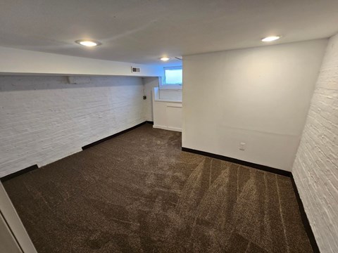A room with brown carpet and white walls.