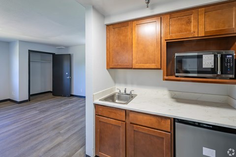 A kitchen with wooden cabinets and a white countertop.
