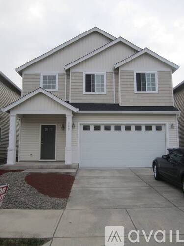 A two-story house with a garage and a front door.