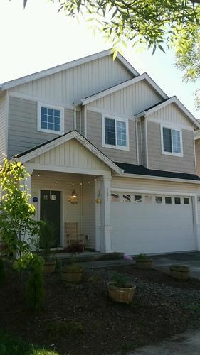 A two-story house with a garage and a front door.