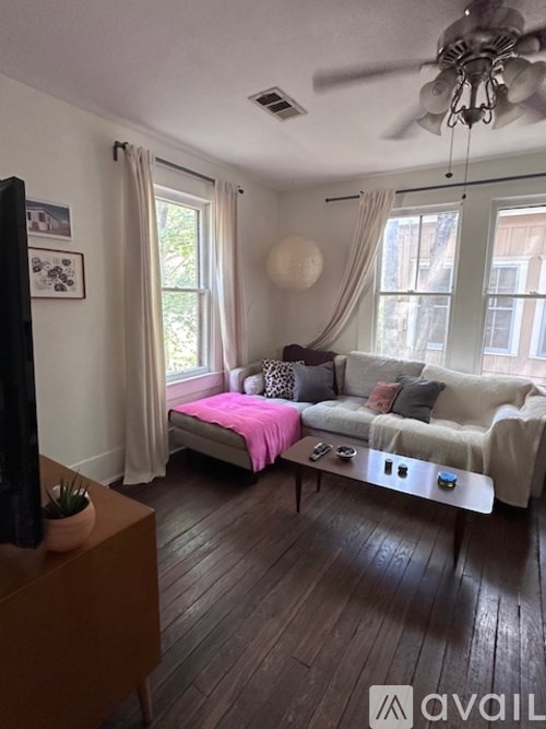 A living room with a couch, a television, and a coffee table.