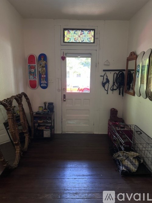 A room with a white door and a window with a stained glass design.