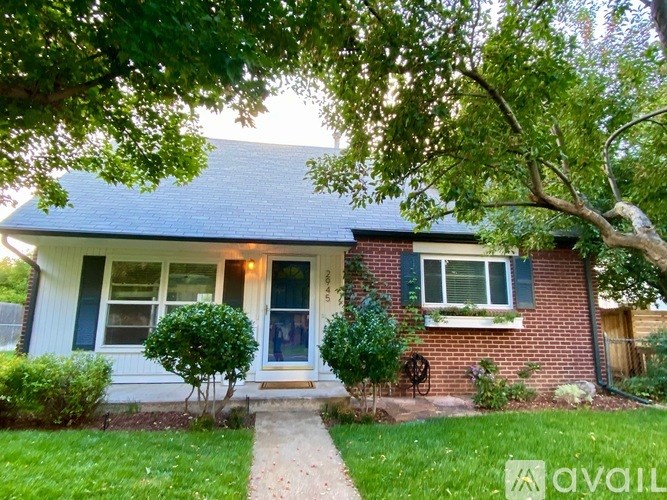 A house with a blue roof and a white front door.