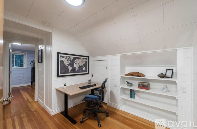 A room with a desk and a chair.