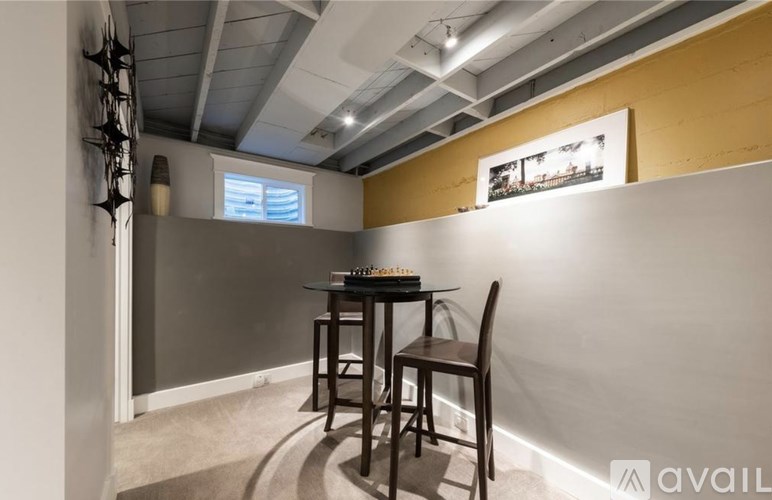 A room with a table and chairs in it.