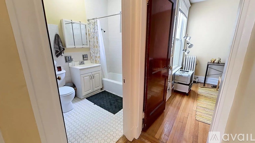 A bathroom with a toilet, sink, and bathtub.