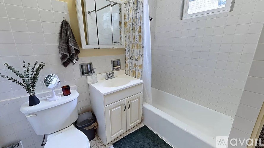 A bathroom with a white toilet, a white sink, and a mirror.