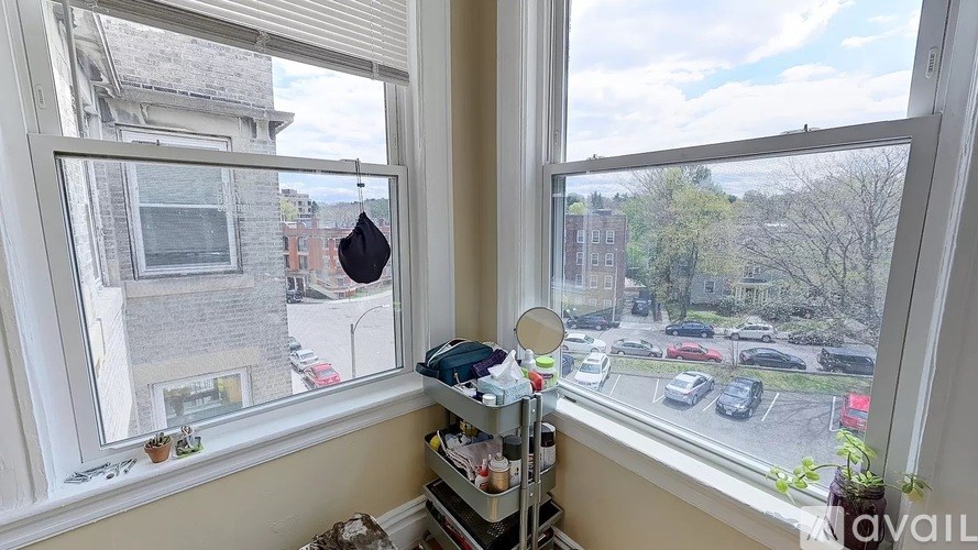 A window seat with a view of a street and buildings outside.