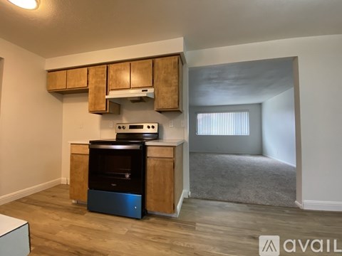A kitchen area with wooden cabinets and a black oven.
