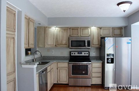 A kitchen with wooden cabinets and stainless steel appliances.