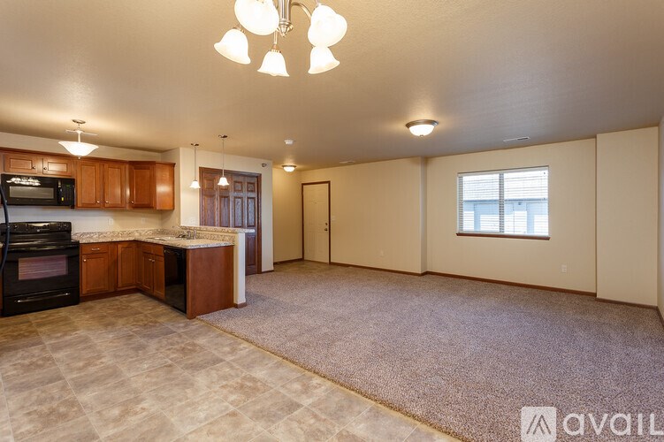 A kitchen with a microwave, oven, and cabinets.
