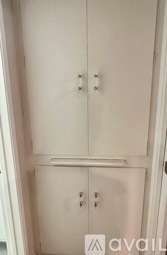 A white cabinet with two doors and two drawers is shown.