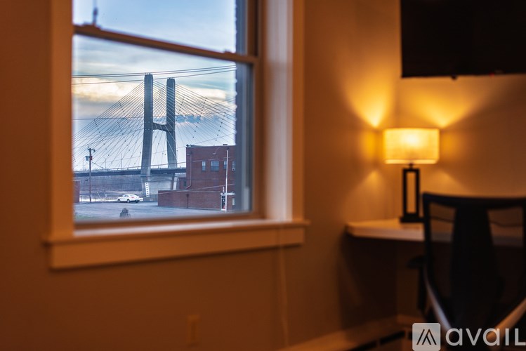 A window with a view of a bridge and a building.