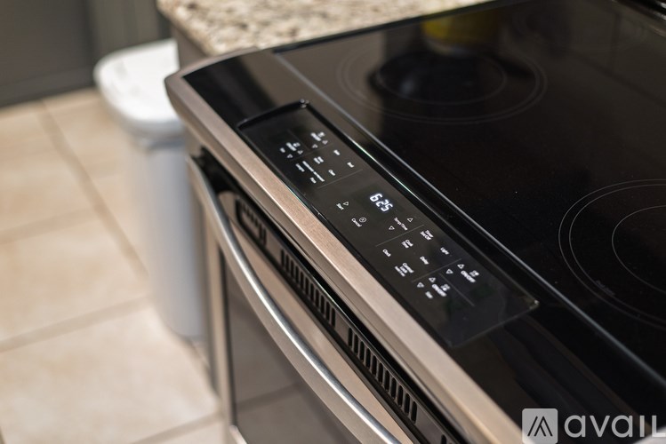 A close up of a stove top with a control panel.