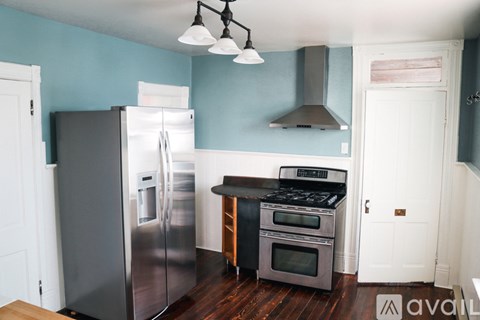 A kitchen with a stainless steel refrigerator and oven.