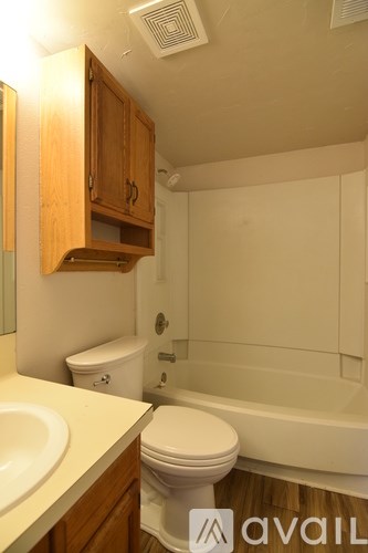 A bathroom with a toilet, sink, and bathtub.
