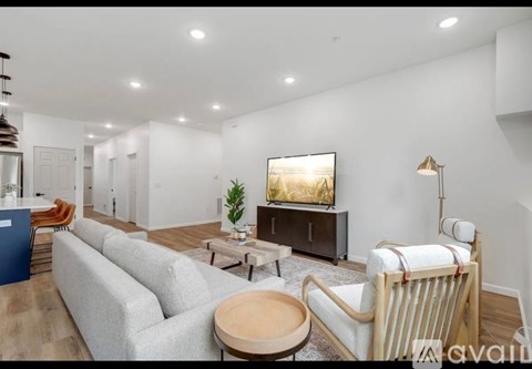 A living room with a television and comfortable seating.