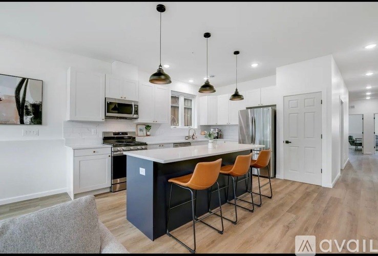 A modern kitchen with a bar area and a dining table.