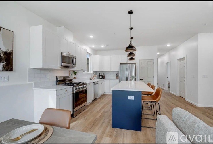 A modern kitchen with a dining table and chairs.