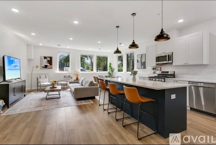 A modern kitchen with a bar area and seating.