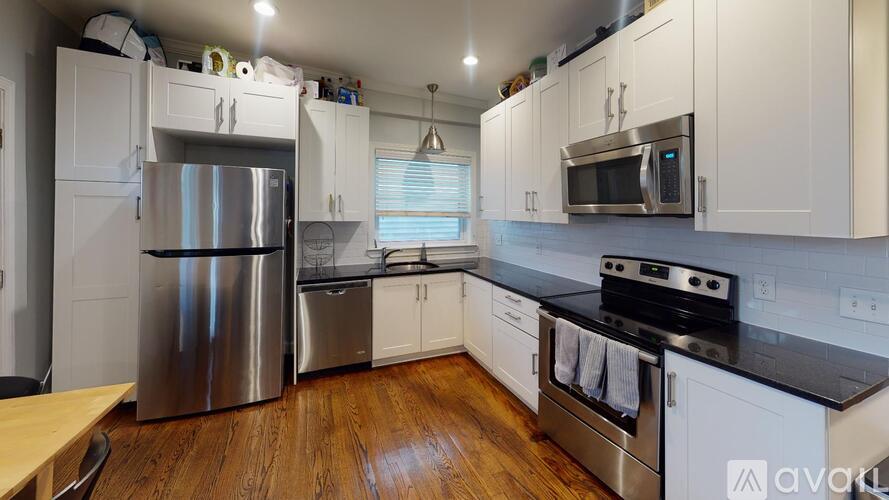 A kitchen with white cabinets and stainless steel appliances.