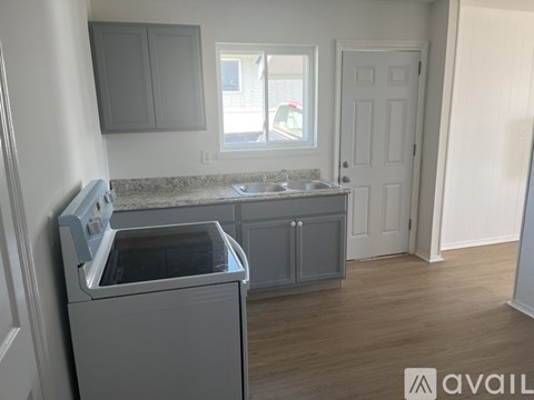 A kitchen with a dishwasher and a window.