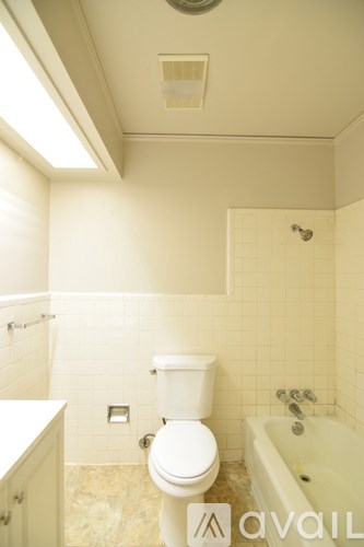 A room with a ceiling fan and a window with blinds.