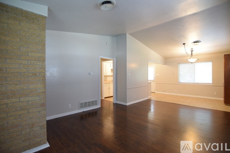 A room with wooden floors and a ceiling fan.