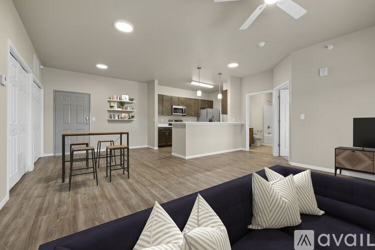 A living room with a dark blue couch and a wooden table.