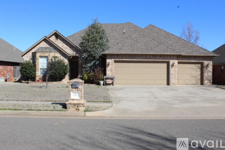 A house with a brick pillar in front of it.